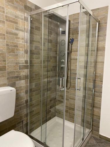 a shower with a glass door in a bathroom at Locanda Tarello 1880 in Roppolo