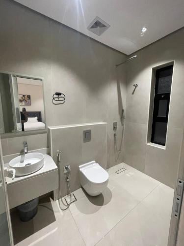 a bathroom with a toilet and a sink at شقة مفروشة in Al Khobar