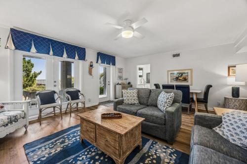 a living room with a couch and a table at Dog Friendly Ground Level Duplex in Fernandina Beach
