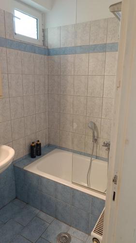 a bathroom with a bath tub and a sink at Lena's Nest Nafpaktos in Nafpaktos