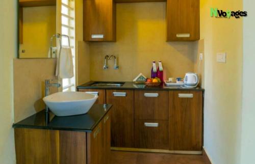 a kitchen with a bowl on top of a counter at Nvoyages Wayanad in Wayanad
