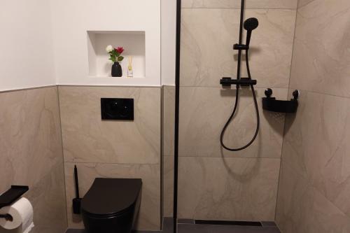 a bathroom with a shower with a toilet and a sink at Hotels-in-Alsdorf in Alsdorf