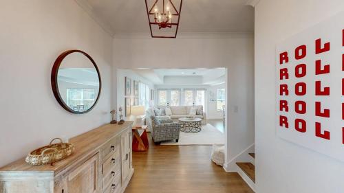 a living room with a mirror on the wall at New Home 3br/25br w/ kayak access sleeps 9 in Orange Beach