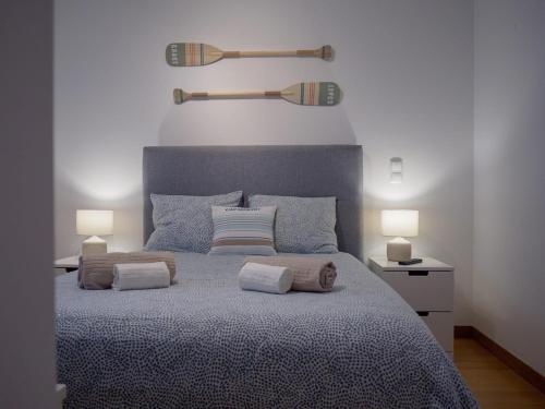 a bedroom with a large bed with two lamps on it at Patio by the sea in Cruz Quebrada