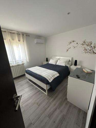 a bedroom with a bed and a wooden floor at Terraço d’Aldeia in São Pedro do Sul