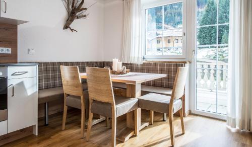 a kitchen with a table and chairs and a window at Apart Garni Elfrieda in Ischgl