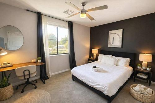a bedroom with a bed and a desk and a window at Serene 1BR Uptown Biltmore Gym Pool Parking WD in Phoenix
