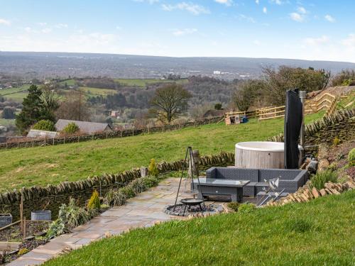 a stone walkway with a bench on a hill at Shutlingsloe in Mellor