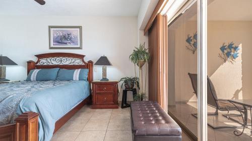 a bedroom with a bed and a table and a chair at Vacation Paradise Relaxing Ocean Front Condo in Puerto Peñasco