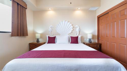 a bedroom with a large white bed with red pillows at Rubi 805 1 BR 1BA Condo Phase 1 @ Las Palomas in Puerto Peñasco