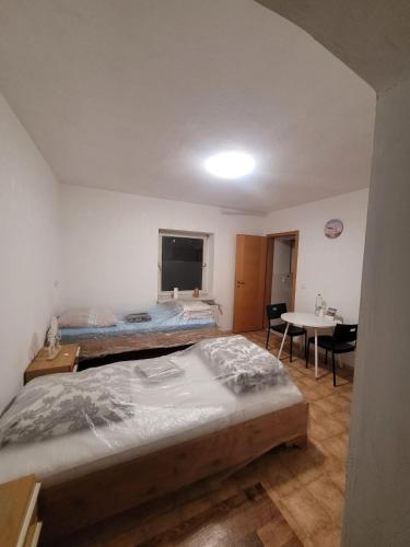 a bedroom with two beds and a desk and a table at Monteurzimmer/Ferienwohnung/Pension in Siegen