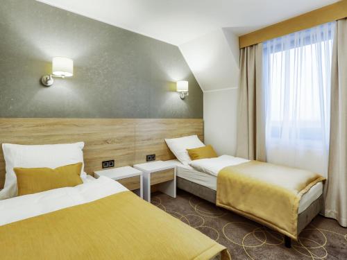 Postel nebo postele na pokoji v ubytování Hotel Antek