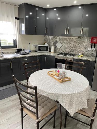 a kitchen with a table and two chairs and a sink at Terraço d’Aldeia in São Pedro do Sul