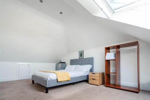 a bedroom with a bed and a mirror at Double room in Bromley in Bromley