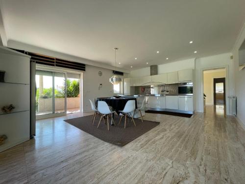 a kitchen and dining room with a table and chairs at Villa Vieira in Alvarães