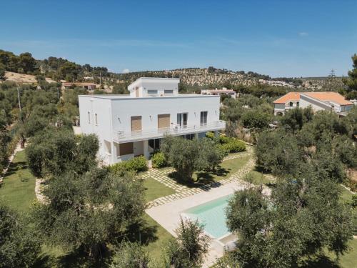 an aerial view of a white house with a swimming pool at Pilone del Monaco - Pool & Free Parking in Vieste