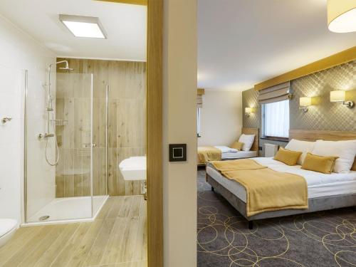 Postel nebo postele na pokoji v ubytování Hotel Antek