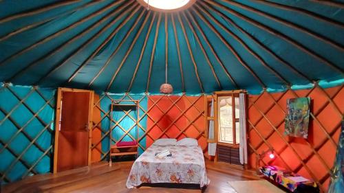 a room with a bed inside of a yurt at Ananda Matha YURTA - Vale do Capão in Palmeiras