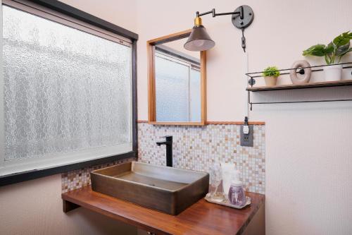 a copper sink in a bathroom with a window at nouveau marche ヌーボーマルシェ in Katori