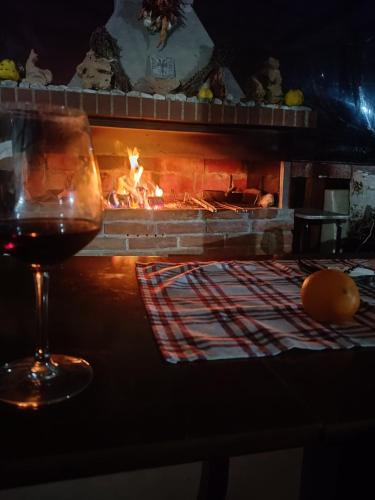 a glass of wine sitting next to a fireplace at Camping SuperPanorama in Kukës