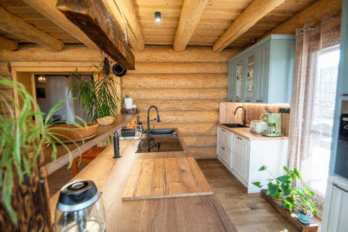 a kitchen with wooden walls and a wooden floor at Zrub Kriváň Chalet with Mountain View in Závažná Poruba