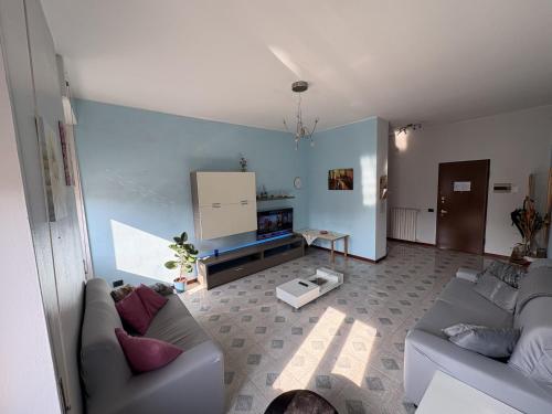 a living room with two couches and a tv at Apartment house in the center in Oggiono