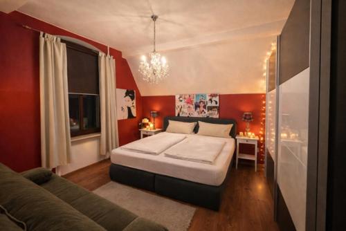 a bedroom with a large bed and a couch at Villa Christina in Kamp-Bornhofen
