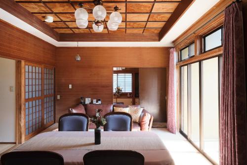 a dining room with a large table and chairs at nouveau marche ヌーボーマルシェ in Katori