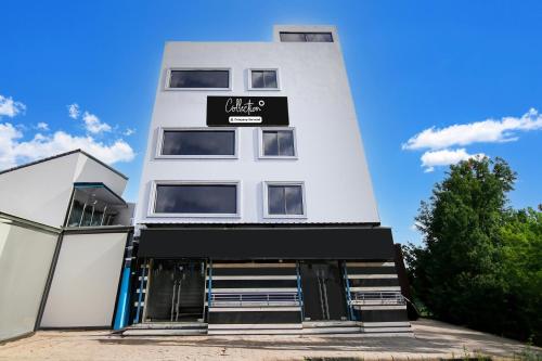 a white building with a black sign on it at Collection O Belgacihia Near Kolkata Railway Station Formerly Beeu Guest House in kolkata