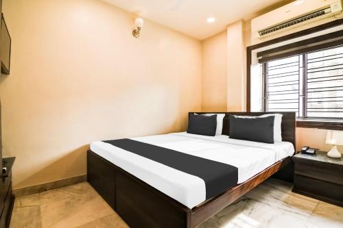 a bedroom with a bed in a room with a window at Collection O Belgacihia Near Kolkata Railway Station Formerly Beeu Guest House in kolkata