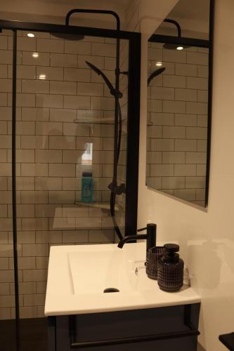 a bathroom with a white sink and a shower at Pretodomar2 in A Coruña
