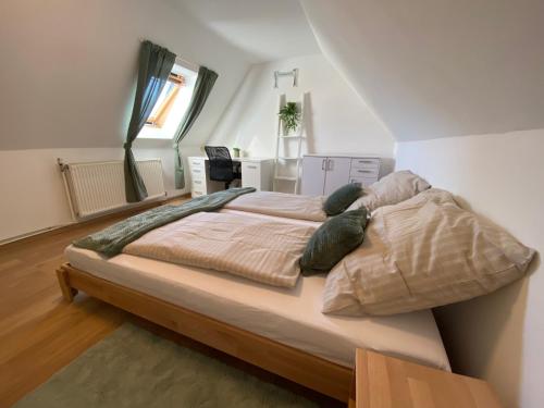 a bedroom with a large bed in a room at Lindo - Historisches Hof-Juwel in Schützen am Gebirge