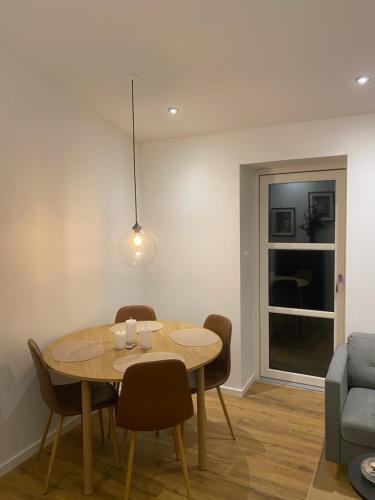 a dining room with a table and chairs and a couch at Moderne bybolig tæt på park og centrum in Horsens