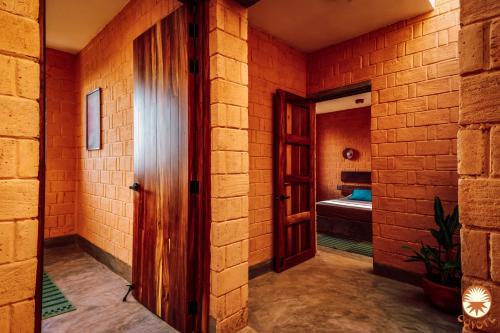 a hallway with an open door to a bedroom at Coyote, 7BR Ocean View Villa, 2 Pools, Zipolite in Puerto Ángel