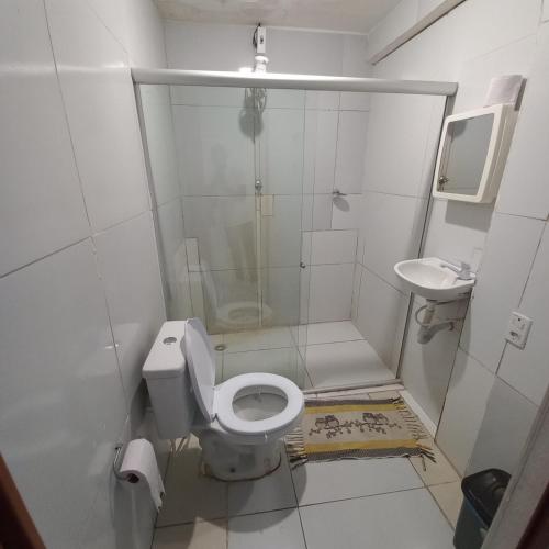 a small bathroom with a toilet and a sink at Hospedagem Setúbal in Recife