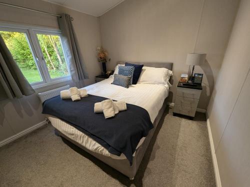a bedroom with a bed with towels on it at Sherwood 33 in Carnforth