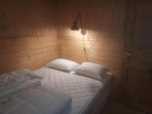 a bedroom with a bed with two pillows on it at Gamlevegen in Fagernes