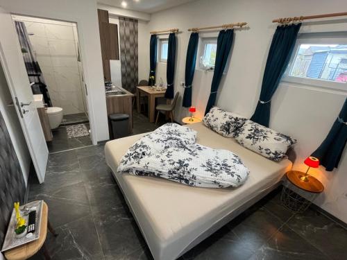 a bedroom with a bed with pillows on it at Privates Studio mit Parkplatz NAC in Euskirchen