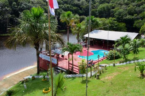 an overhead view of a resort with a pool and palm trees at Angatu Amazon Jungle Lodge in Iranduba