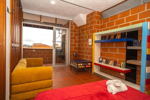 a lego room with a bed and a couch at Hotel Spa Bliss Guatape in Guatapé
