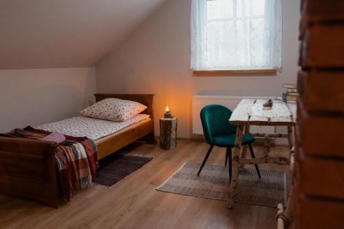 a bedroom with a bed and a table with a candle at Gajówka Wiry in Pawłowa