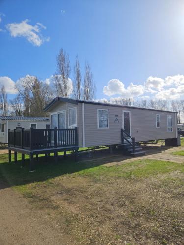 a mobile home with a porch and a deck at Billing Aquadrome Holiday Park with Fishing Lakes in Great Billing