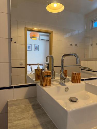a bathroom with a sink and a mirror at Ora Stay in Papeete