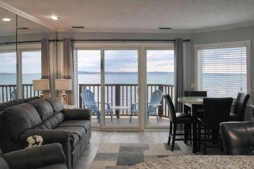 a living room with a couch and a table and chairs at Beachside 218 Luxury Condo on the Beach in Traverse City