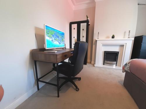 a desk with a computer on it in a room at Peaceful Room Overlooking Nature & Parking in Bloxwich