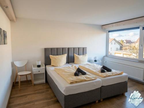 a bedroom with a large bed and a window at Aviva SEEPANORAMA - Großzügige 85m Wohnung mit Bodenseeblick in Bodman-Ludwigshafen