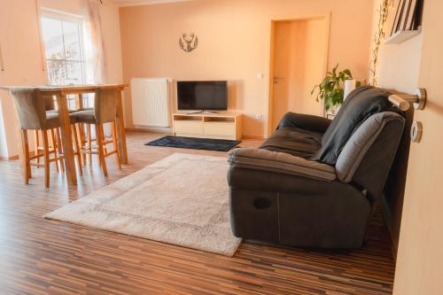 a living room with a couch and a table at FeWo Böhaming in Schaufling