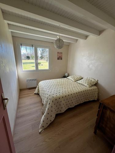 a bedroom with a bed and a window at T2 charmant dans les Landes in Lesperon