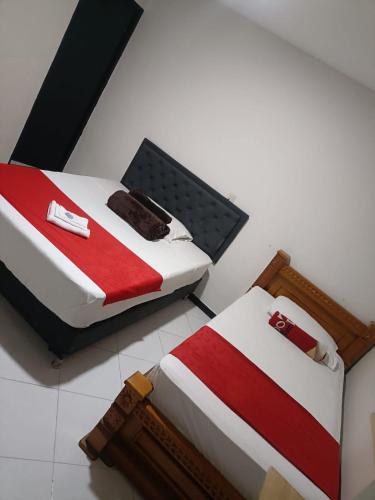 two beds sitting next to each other in a room at Hotel Picasso 70 in Medellín