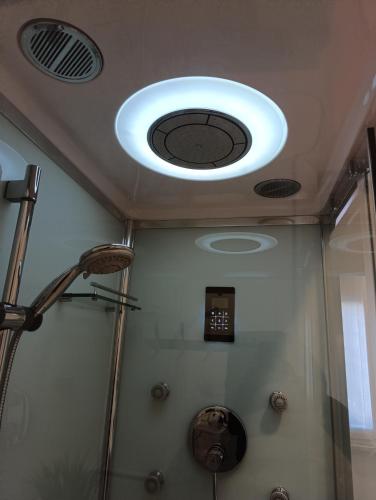 a bathroom with a shower with a ceiling with a light at Suite Cinque terre Portovenere in La Spezia